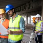 Construction engineers discussion with architects at construction or building site