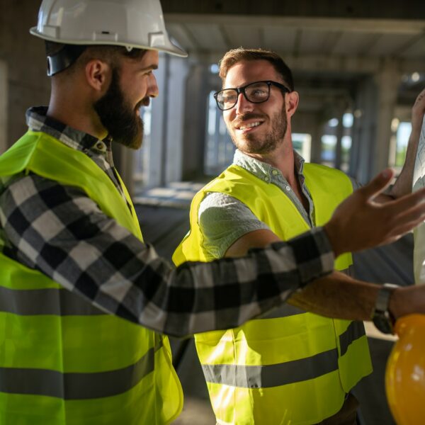 Construction engineers discussion with architects at construction or building site