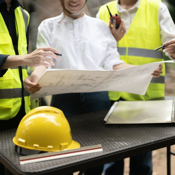 Construction engineers discussion with architects at construction or building site