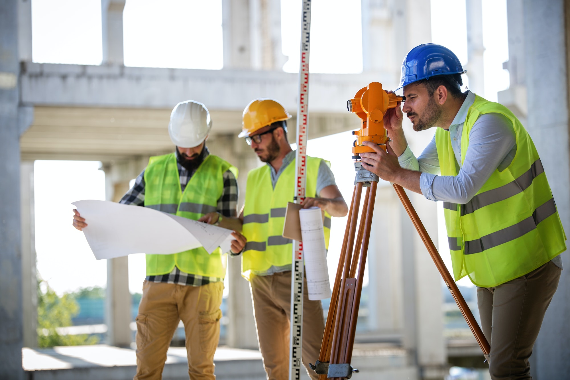 Construction engineers discussion with architects at construction or building site